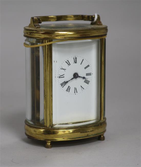 A late 19th century French oval brass cased miniature eight day carriage timepiece height 22cm